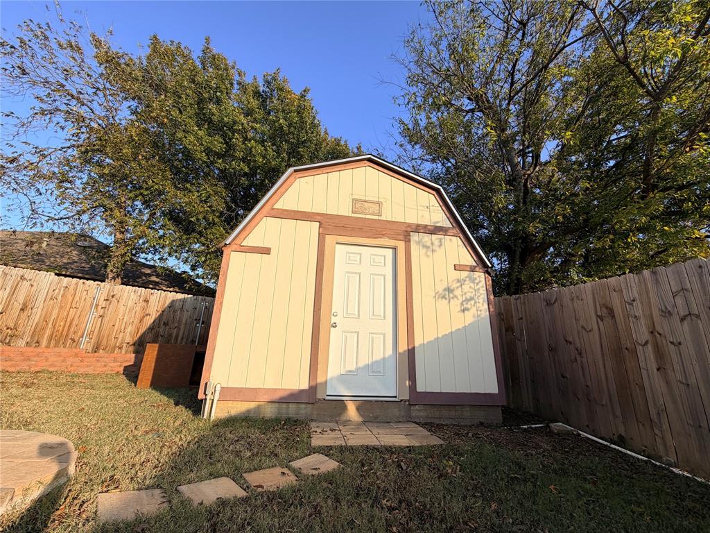 7205 Windcrest Court East North Richland Hills, TX 76182 - Photo 26 of 35 a view of backyard with tree and wooden fence