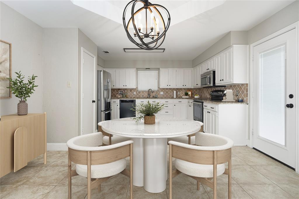 7205 Windcrest Court East North Richland Hills, TX 76182 - Photo 3 of 35 a kitchen with stainless steel appliances a table and chairs