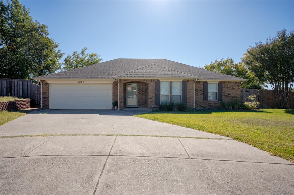 7205 Windcrest Court East North Richland Hills, TX 76182 - Photo 9 of 35 a front view of a house with a garden and trees