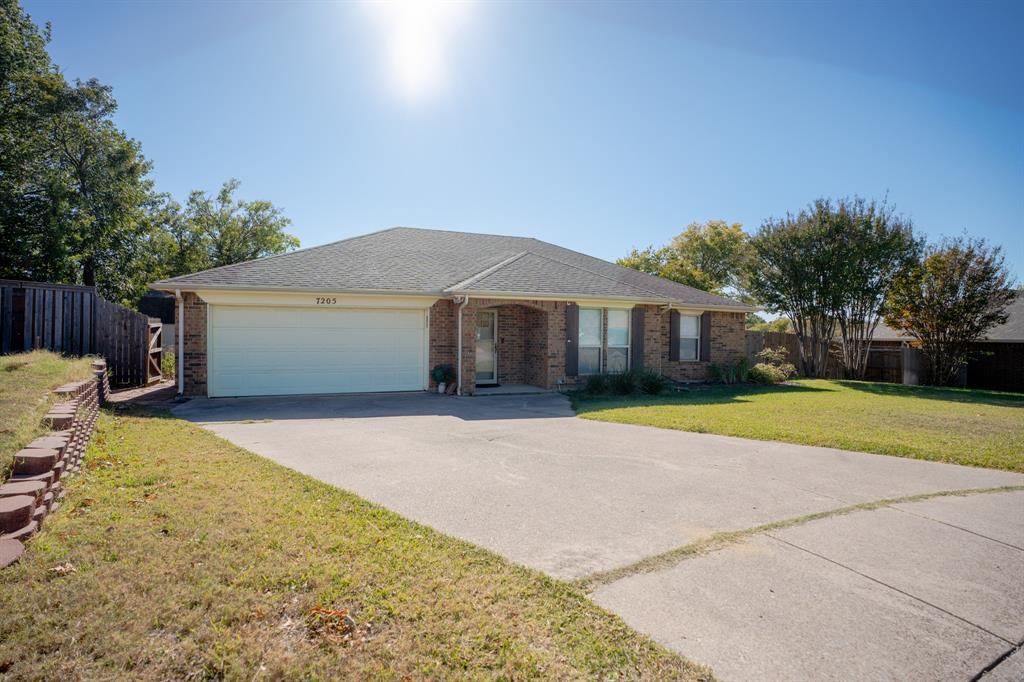 7205 Windcrest Court East North Richland Hills, TX 76182 - Photo 10 of 35 a front view of a house with a yard and garage