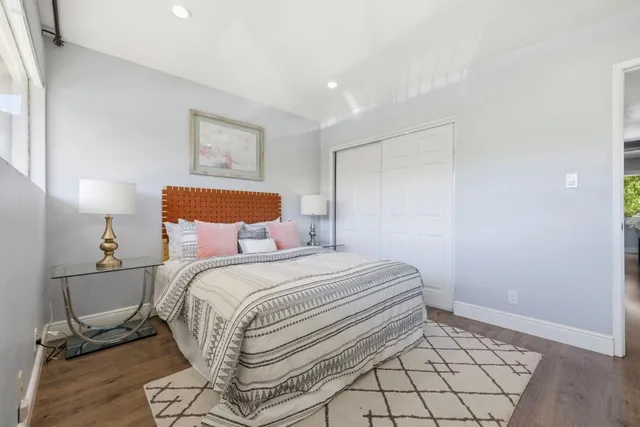 a bedroom with a bed and a table