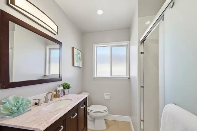 a bathroom with a sink a toilet and mirror