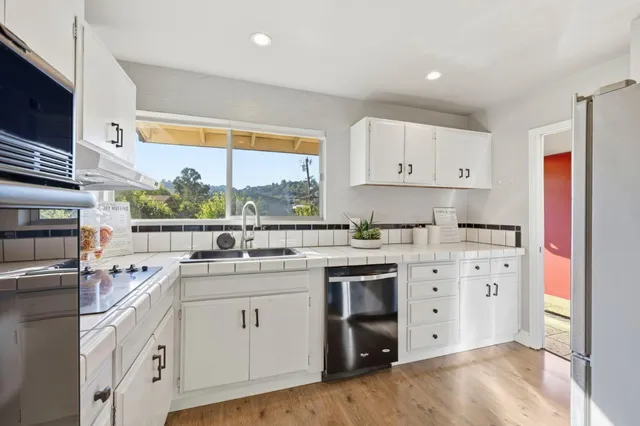 a kitchen with a sink stove and cabinets