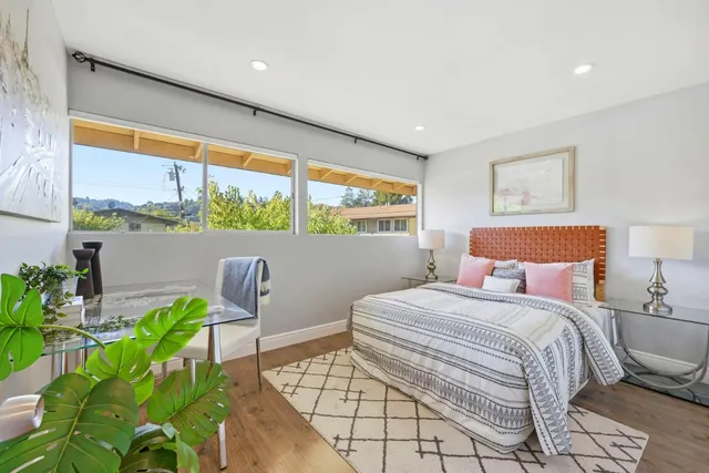 a bedroom with a bed and a chair