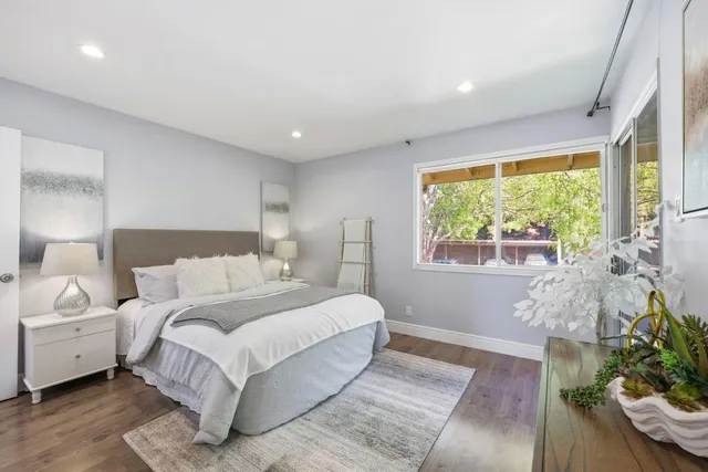 a bedroom with a large bed and a large window