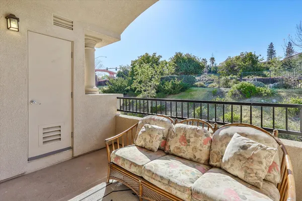 a balcony with table and chairs