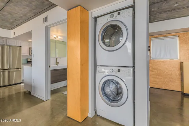 a large white kitchen with a large window
