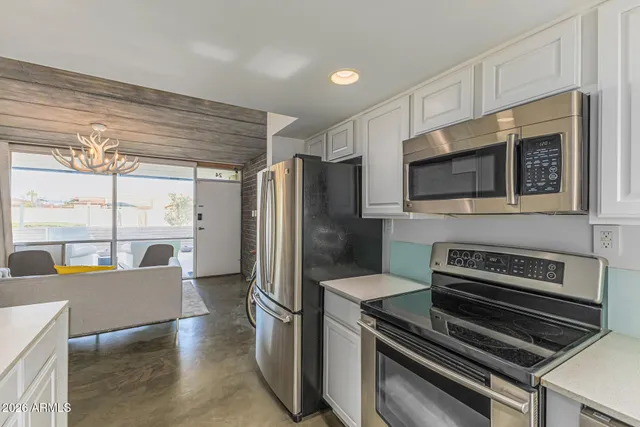 a kitchen with a sink stove top oven and microwave