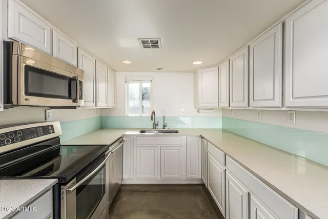 a view of a kitchen with furniture and empty shelves