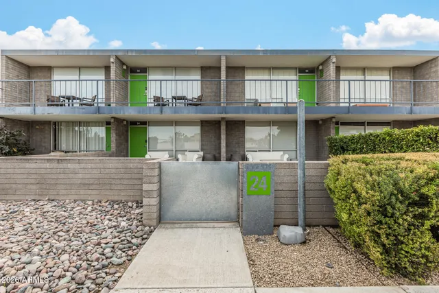 a view of a patio with table and chairs with wooden floor and fence