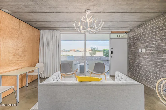 a room with pool table and windows