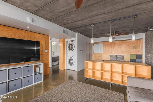 a bedroom with a bed and a wall painting