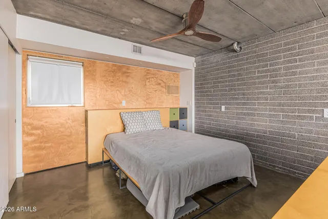 a bedroom with a bed a table and chairs