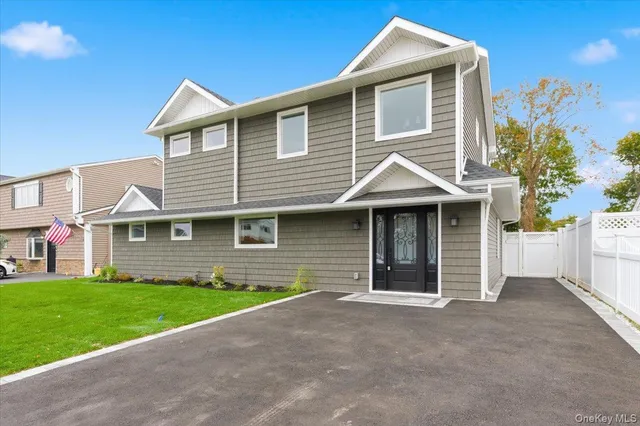 a front view of a house with a garden and yard