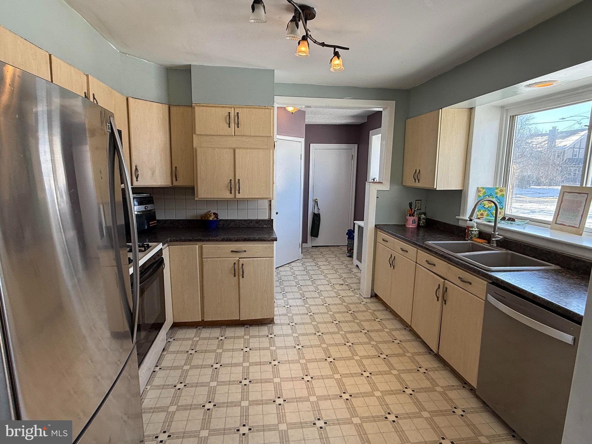 530 Kenmore Road Havertown, PA 19083 - Photo 8 of 25 a kitchen with a sink a stove a refrigerator a window and cabinets