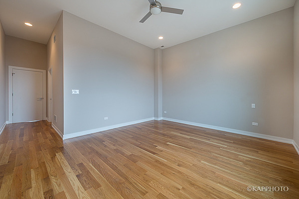 2835 West Division Street, Unit 1W Chicago, IL 60622 - Photo 16 of 39 wooden floor in an empty room with a window