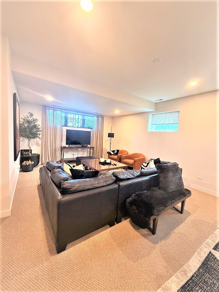 2835 West Division Street, Unit 1W Chicago, IL 60622 - Photo 31 of 39 a living room with furniture and a flat screen tv