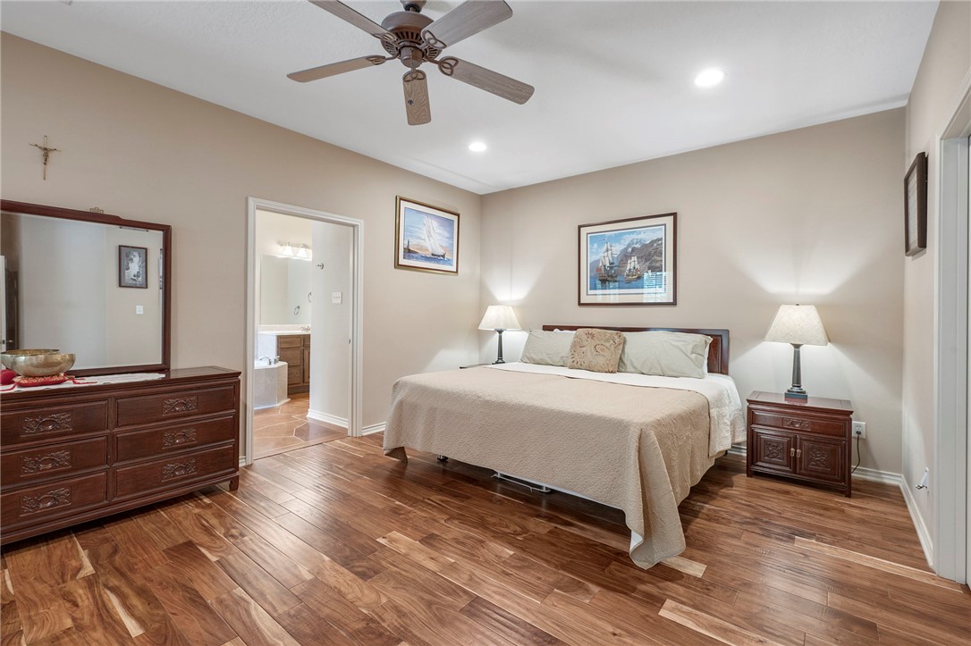 4960 Drake Drive College Station, TX 77845 - Photo 14 of 31 a spacious bedroom with a bed and a chandelier
