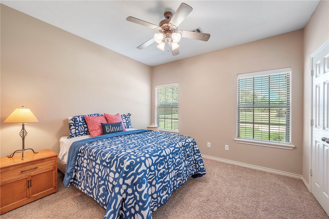 4960 Drake Drive College Station, TX 77845 - Photo 18 of 31 a bedroom with a bed and a chandelier
