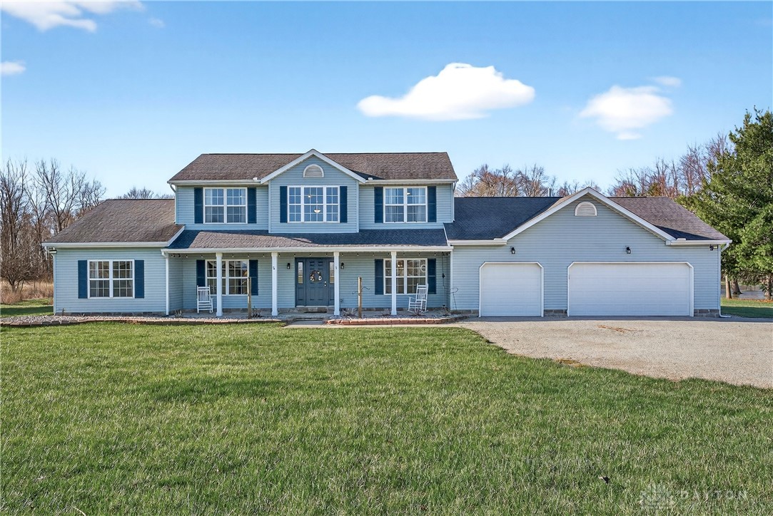 This classic two-story residence features a welcoming front porch and an attached garage.