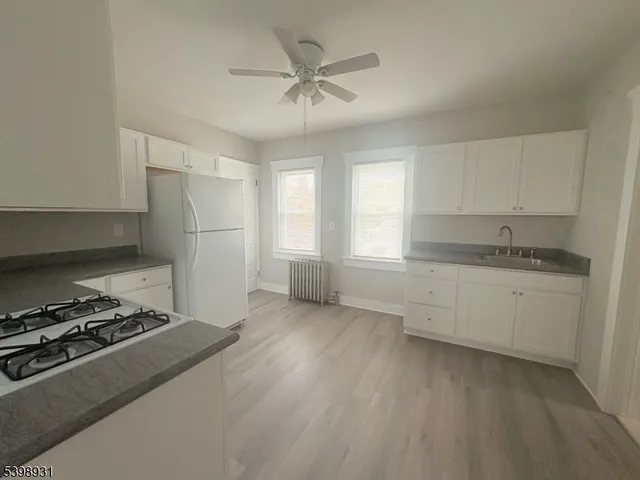 a kitchen with stainless steel appliances granite countertop a stove and a refrigerator