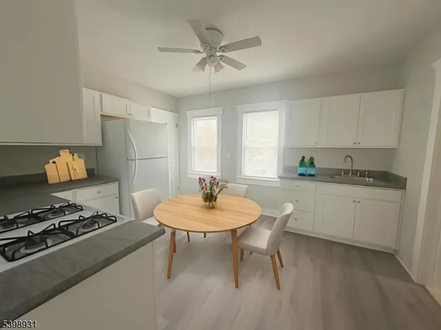 a kitchen with a stove cabinets and window