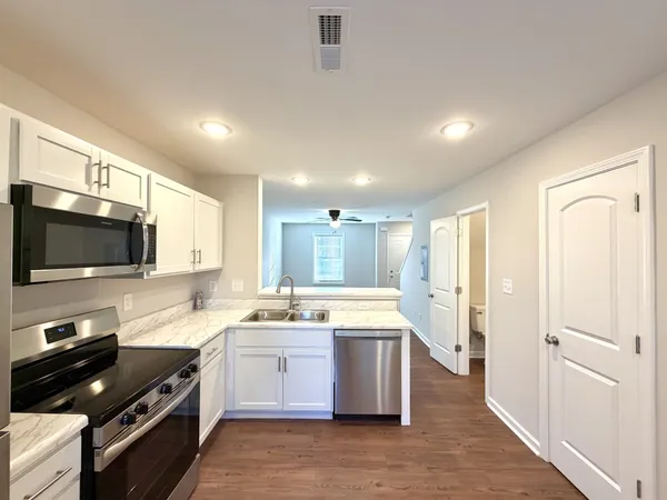a kitchen with a sink stainless steel appliances and cabinets