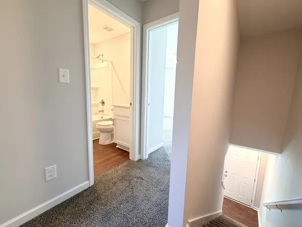 a view of an empty room and a window