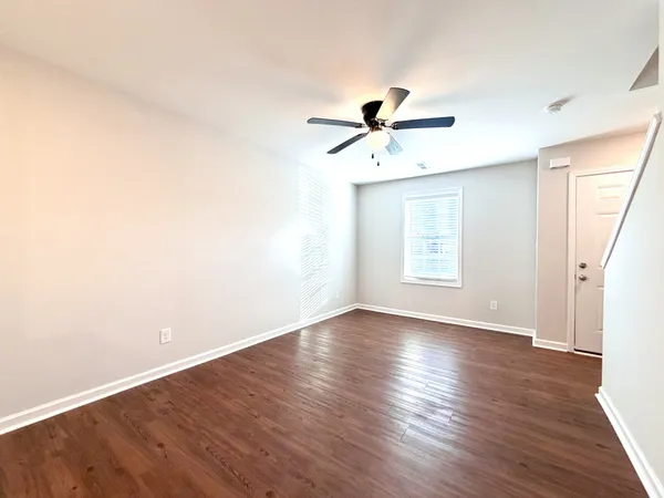 wooden floor in an empty room with a window