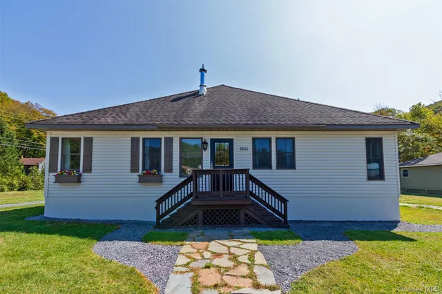 a kitchen with stainless steel appliances granite countertop a stove a sink dishwasher and a refrigerator with wooden floor