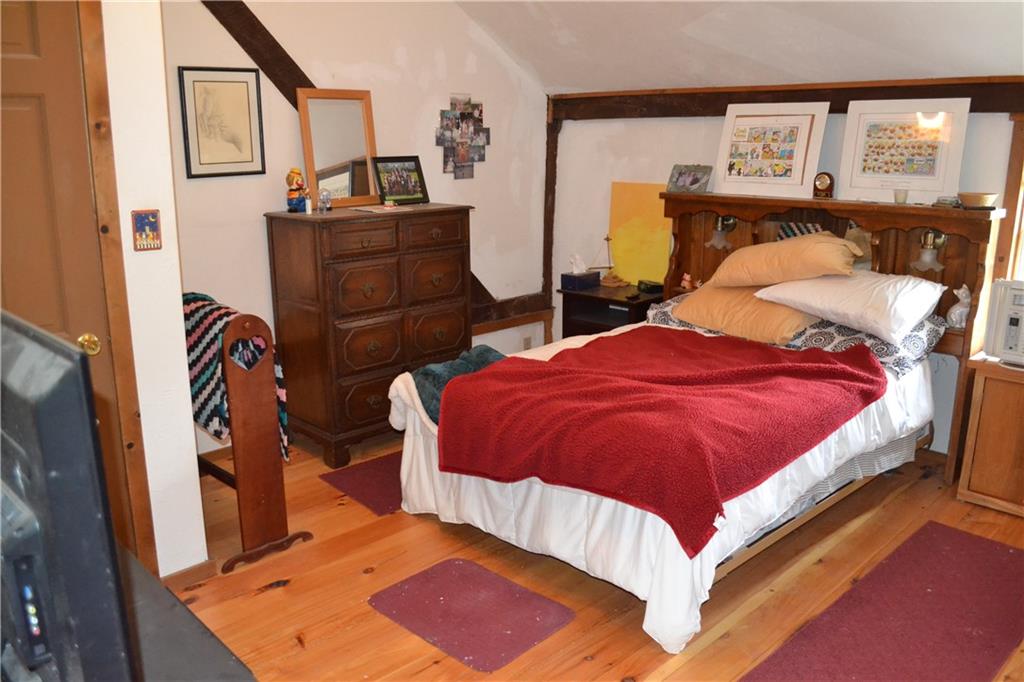 274 Gressly Road Ruffs Dale, PA 15679 - Photo 36 of 49 a bedroom with a bed and wooden floor