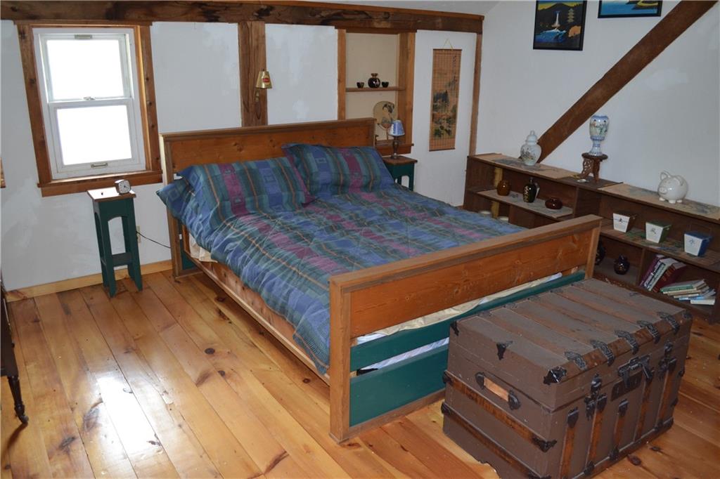 274 Gressly Road Ruffs Dale, PA 15679 - Photo 40 of 49 a bed sitting in a bedroom next to a window with wooden floor