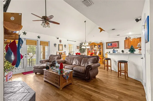a view of a dining room with furniture and chandelier