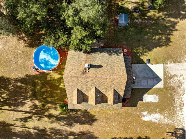 a view of an swimming pool and trees