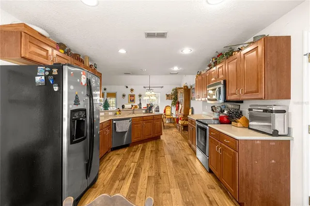 a dining room with furniture large window and wooden floor