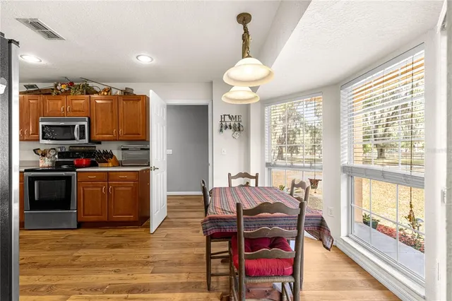 a view of a workspace with furniture and wooden floor