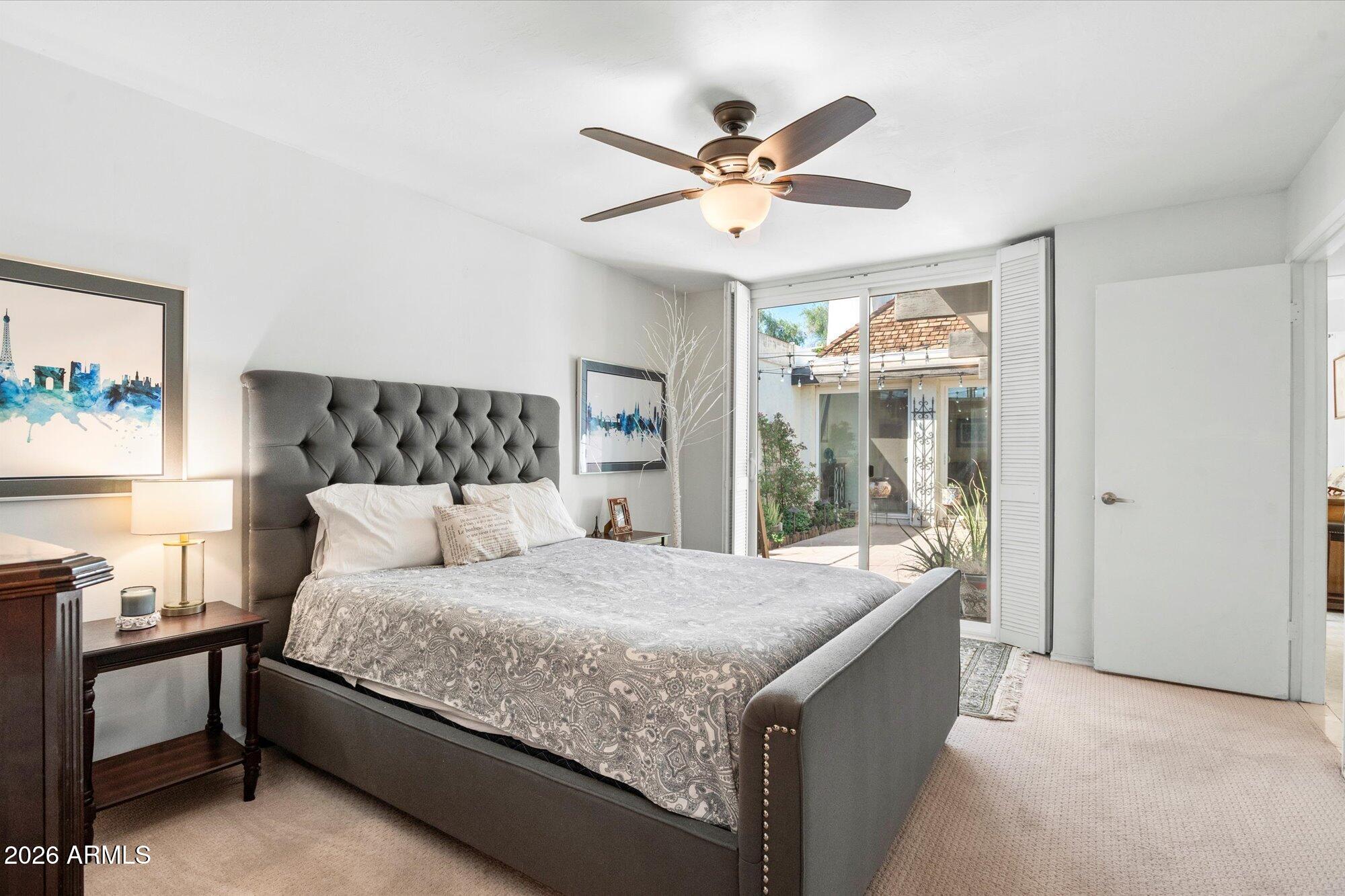 7005 North Barbados Place Phoenix, AZ 85021 - Photo 24 of 42 a bedroom with a large bed and a chandelier