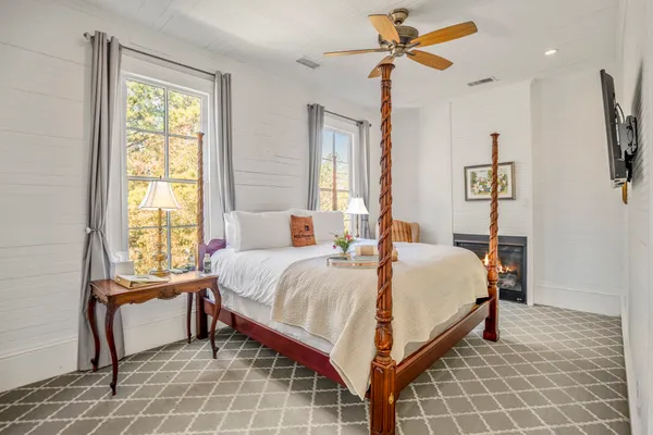 a bedroom with a bed and a window