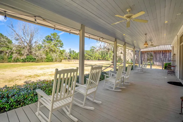 a view of a chairs and table in patio with wooden floor