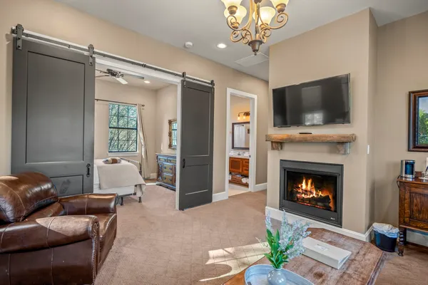 a living room with furniture a flat screen tv and a fireplace