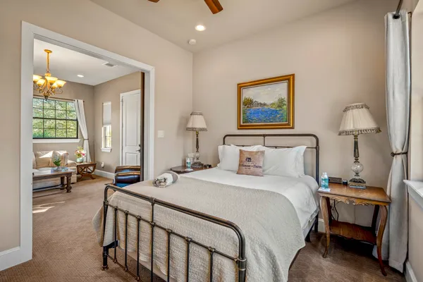 a bedroom with a bed and a painting on the wall