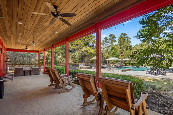 a view of a porch with furniture and a yard