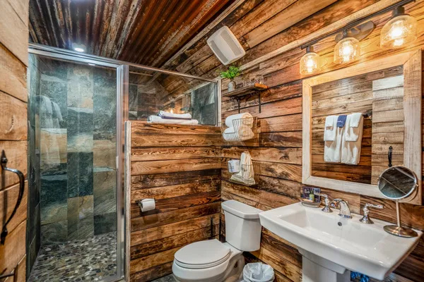 a bathroom with a sink toilet and shower