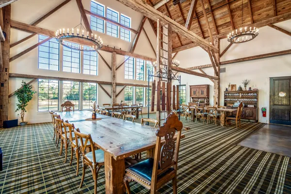 a view of a patio with table and chairs and floor to ceiling window