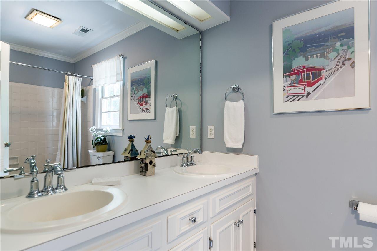10708 Dunhill Terrace Raleigh, NC 27615 - Photo 22 of 25 a bathroom with a double vanity sink and a mirror