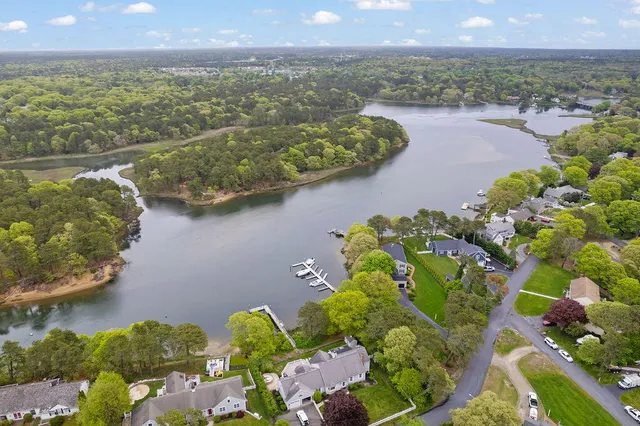a living room with furniture a fireplace and a large window