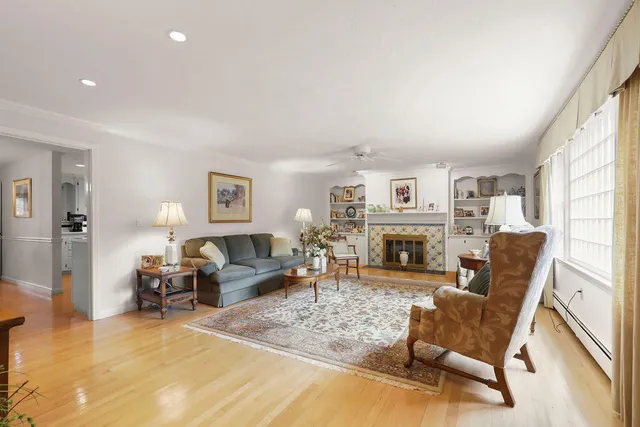 a living room with furniture and a floor to ceiling window