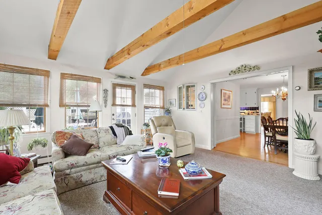 a living room with furniture tv and a window