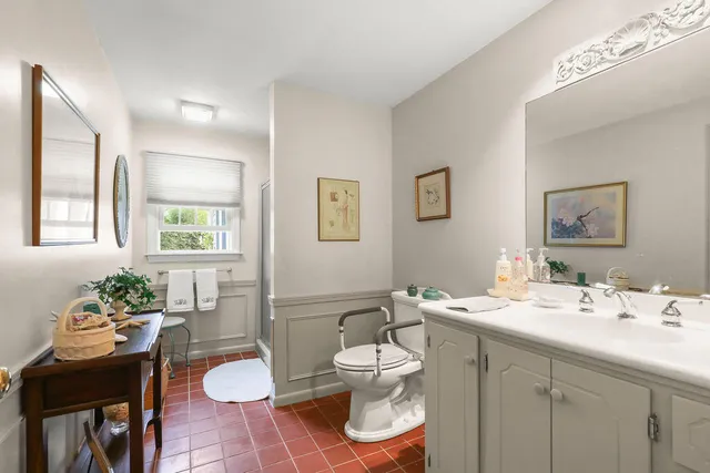 a bedroom with a bed a couch and dresser