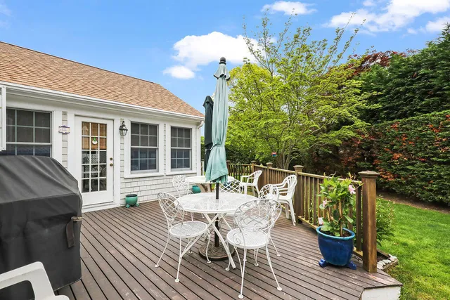 a view of a house with a yard and sitting area